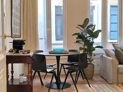 a living room with a table and chairs at Lovely City Centre Duplex in Antwerp