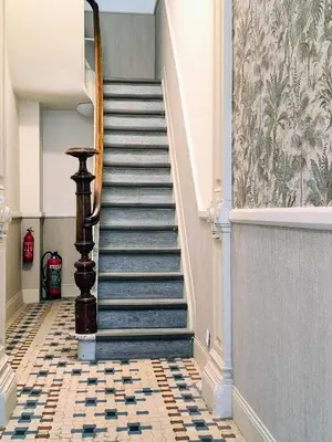 a staircase in a building with a tile floor at Lovely City Centre Duplex in Antwerp