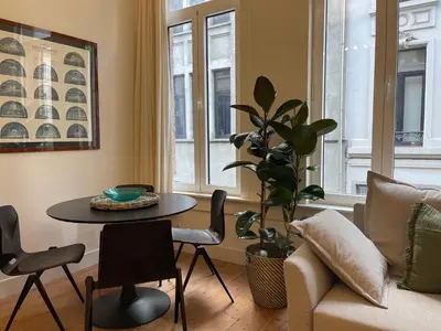 a living room with a table and a couch at Lovely City Centre Duplex in Antwerp