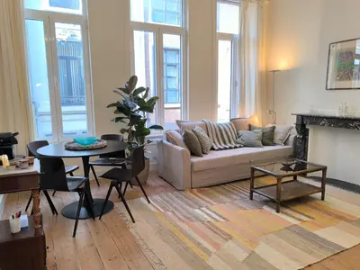 a living room with a couch and a table at Lovely City Centre Duplex in Antwerp