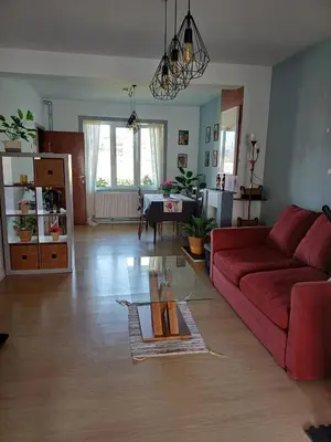 a living room with a red couch and a table at Apartment with terrace in Berchem-Sainte-Agathe in Brussels