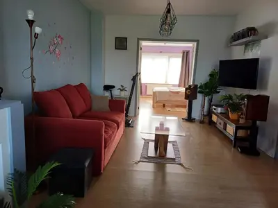 a living room with a red couch and a tv at Apartment with terrace in Berchem-Sainte-Agathe in Brussels