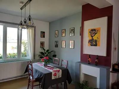 a dining room with a table and a fireplace at Apartment with terrace in Berchem-Sainte-Agathe in Brussels