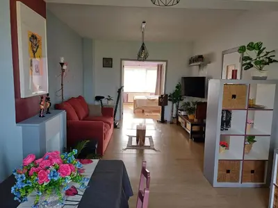 a living room with a red couch and a table at Apartment with terrace in Berchem-Sainte-Agathe in Brussels