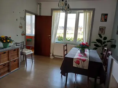 a dining room with a table with flowers on it at Apartment with terrace in Berchem-Sainte-Agathe in Brussels