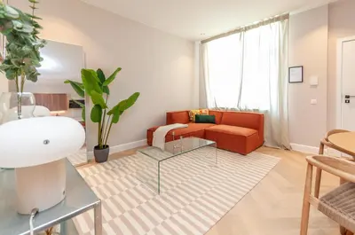 a living room with a couch and a glass table at Modern Stay in Antwerp in Antwerp