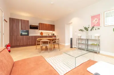 a living room with a table and a kitchen at Modern Stay in Antwerp in Antwerp