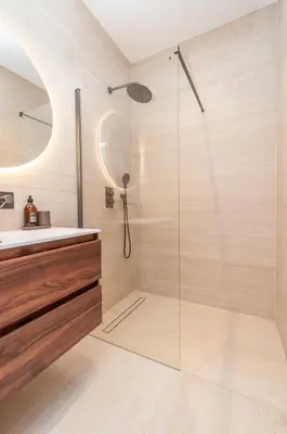 a bathroom with a glass shower with a sink at Modern Stay in Antwerp in Antwerp