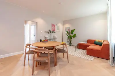 a living room with a table and a couch at Modern Stay in Antwerp in Antwerp