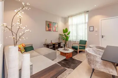 a living room with a couch and a table at Stylish Apartment in 't Zuid in Antwerp