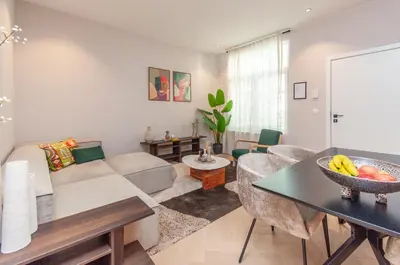 a living room with a couch and a table at Stylish Apartment in 't Zuid in Antwerp