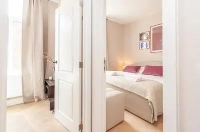 a bedroom with a bed with red pillows at Stylish Apartment in 't Zuid in Antwerp