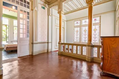 an empty room with windows and a wooden podium at Boutique Cogels Osy Suite Four Garden in Antwerp