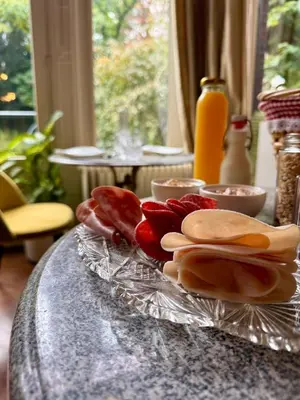 a table with a plate of food on it at Boutique Cogels Osy Suite Four Garden in Antwerp