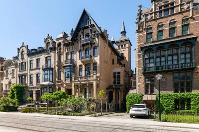 a building with a car parked in front of it at Boutique Cogels Osy Suite Four Garden in Antwerp