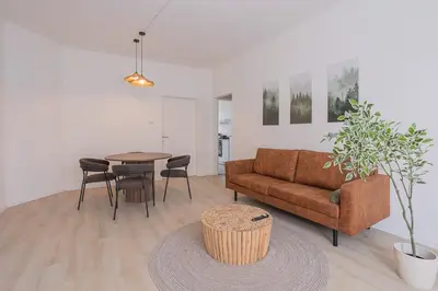 a living room with a couch and a table at Chic Antwerp Stay 3BR Comfort in Antwerp