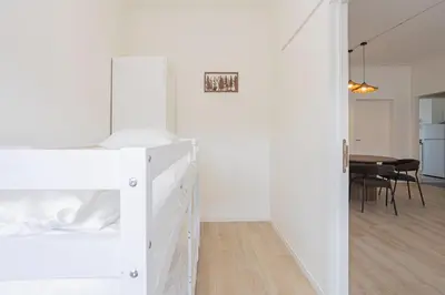 a bedroom with a bunk bed and a dining room at Chic Antwerp Stay 3BR Comfort in Antwerp