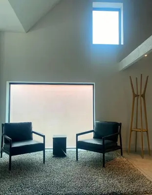 two chairs sitting in a room with a window at Hoeve DeKleinheide - De Hoeve in Dessel