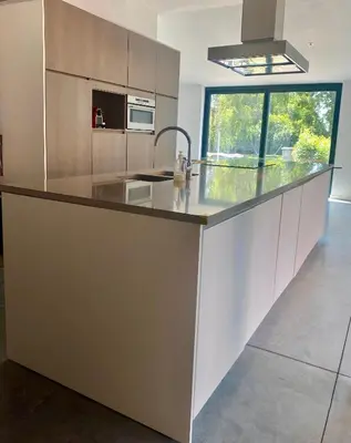 a kitchen with a large counter with a sink at Hoeve DeKleinheide - De Hoeve in Dessel