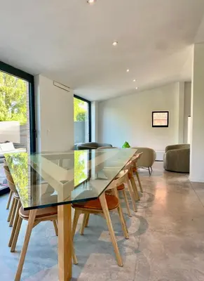 a dining room with a glass table and chairs at Hoeve DeKleinheide - De Hoeve in Dessel