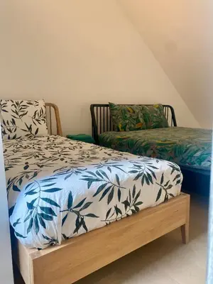 a bedroom with a bed and a couch in a room at Hoeve DeKleinheide - De Hoeve in Dessel