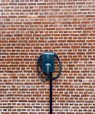 a blue parking meter on a brick wall at Hoeve DeKleinheide - De Hoeve in Dessel
