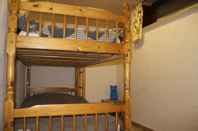a wooden bunk bed in a room with a wall at Hof Ter Hagen in Lokeren