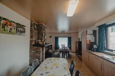a dining room with a table and chairs in a room at Hof Ter Hagen in Lokeren