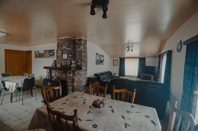 a living room with a table and a couch at Hof Ter Hagen in Lokeren