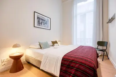 a bedroom with a large bed and a window at The Ghentian Suites by Domani Hotels in Ghent