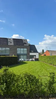 a building with a lawn in front of it at Bruggeske aan't bos in Mol