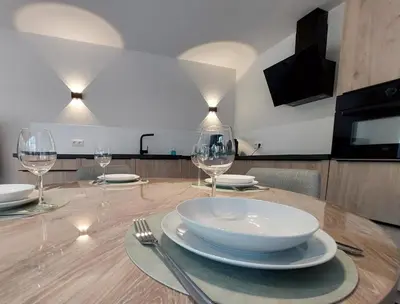 a table with plates and wine glasses on it at Vakantiewoning in 't groen-Lille in Lille