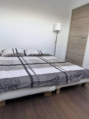 a bedroom with a large bed with a lamp at House for TOMMORLAND 700 m in Boom 2850 in Boom