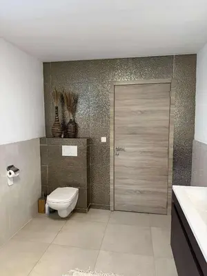 a bathroom with a toilet and a sliding door at House for TOMMORLAND 700 m in Boom 2850 in Boom