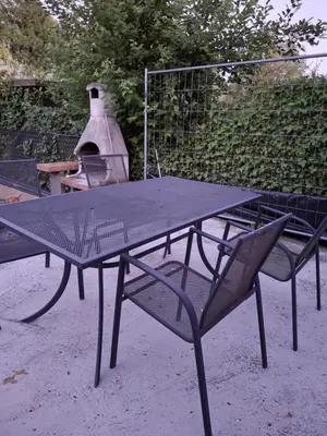 a picnic table and chairs with a pizza oven at House for TOMMORLAND 700 m in Boom 2850 in Boom