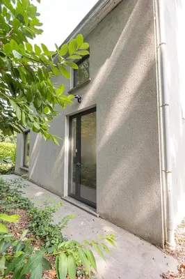 a house with a glass door on the side of it at Secret garden