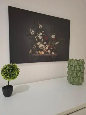 a painting of a vase of flowers on a shelf at Secret garden