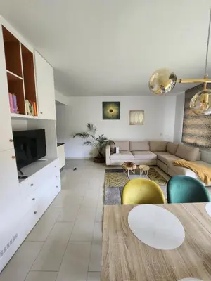 a living room with a couch and a table at Gezellig verblijf met balkon in Brussels
