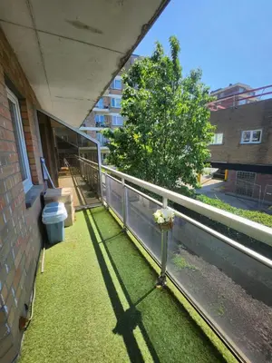 a balcony with green grass and a tree on a building at Gezellig verblijf met balkon in Brussels