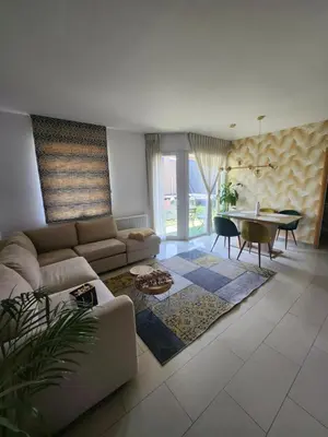 a living room with a couch and a table at Gezellig verblijf met balkon in Brussels