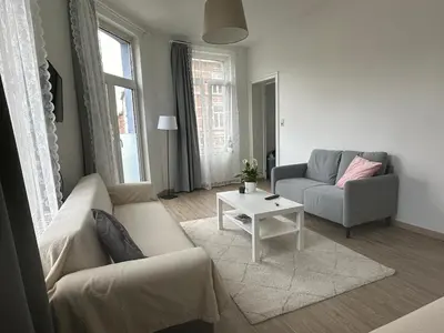 a living room with a couch and a table at Midi Retreat in Brussels