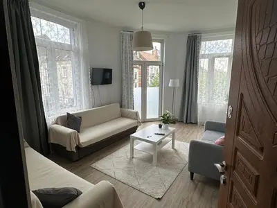 a living room with a couch and a table at Midi Retreat in Brussels