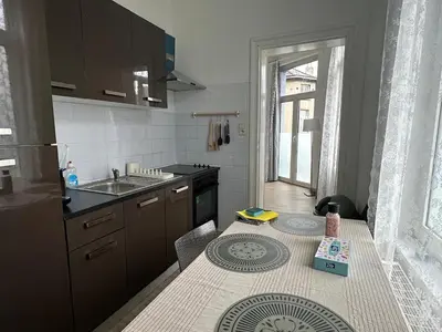 a small kitchen with a table and a sink at Midi Retreat in Brussels