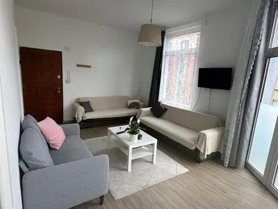 a living room with two couches and a table at Midi Retreat in Brussels