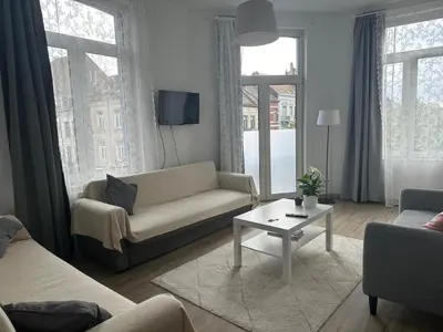 a living room with a couch and a table at Midi Retreat in Brussels