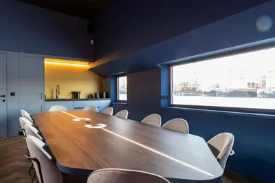 a conference room with a wooden table and chairs at Cyberdeck for big groups in Ghent