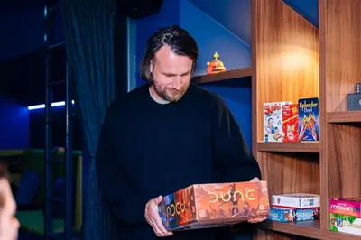 a man is holding a large bag of food at Cyberdeck for big groups in Ghent