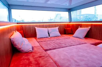 a seat in the back of a boat with pillows at Cyberdeck for big groups in Ghent