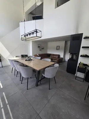 a dining room with a wooden table and chairs at Tomorrowland Crib in de buurt van Boom in Schelle