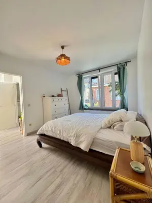 a bedroom with a large bed and a window at Tiny House avec terrasse privée, 10 mins du centre in Brussels